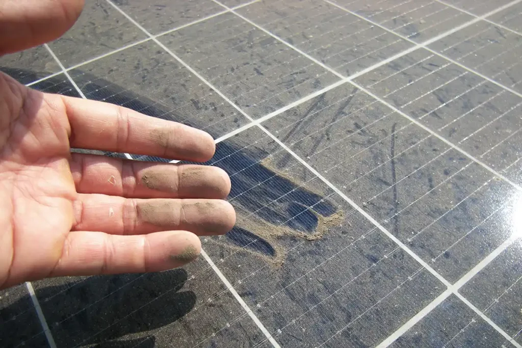 Image shows a man checking the solar panels to see if they need to be replaced
