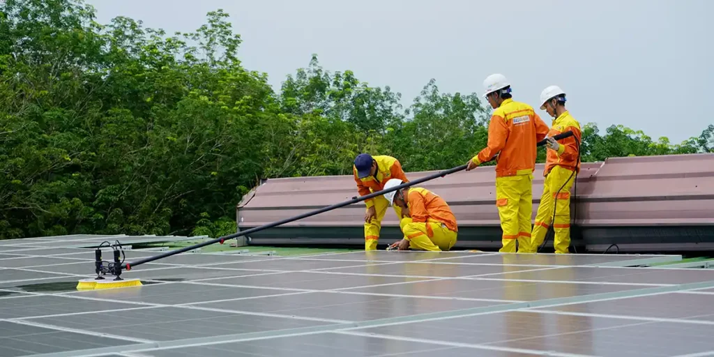 Men Pressure Washing Solar Panels