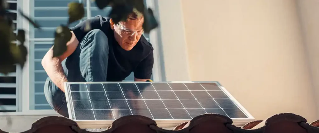 Image of a man installing solar panels