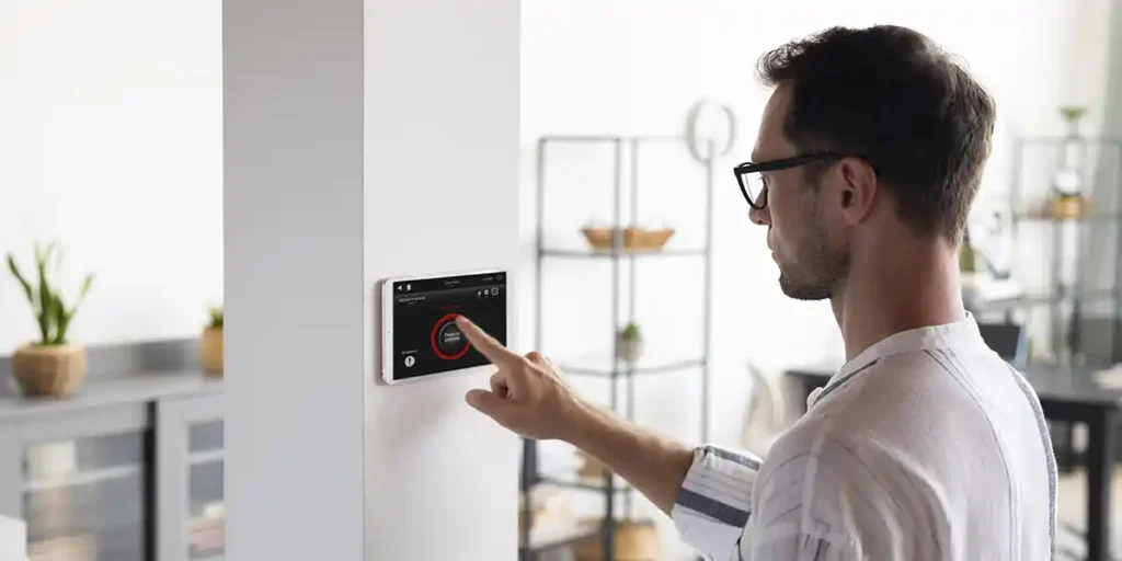 Man using Thermostat as a part of his solar energy system
